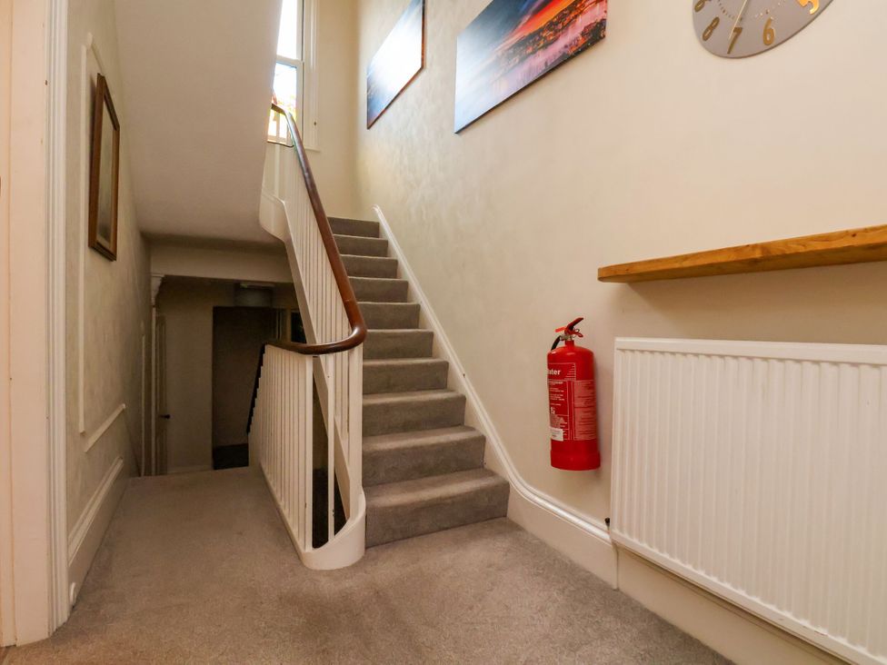 A staircase with a fire extinguisher in a hallway at Sunnyvale House in Whitby