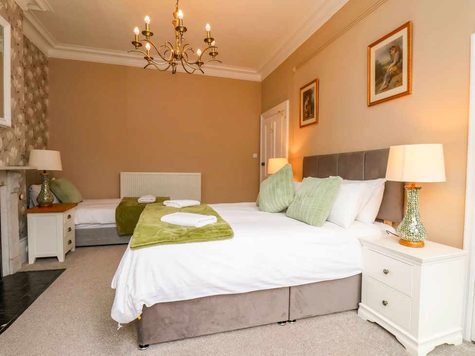 A bedroom with two beds and a nightstand at Sunnyvale House in Whitby