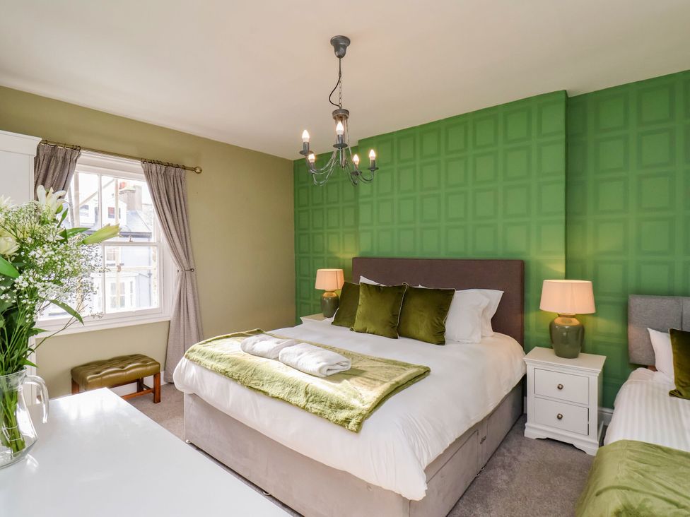 A bedroom with two beds and a window at Sunnyvale House in Whitby