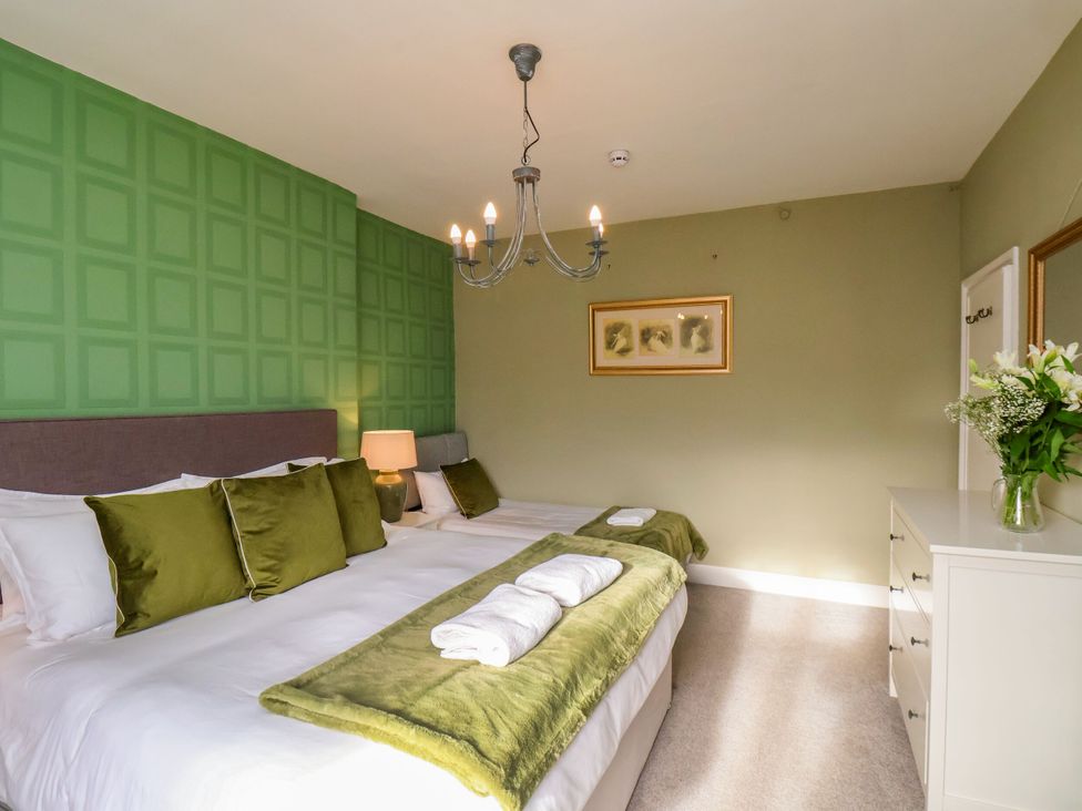 A bedroom with a bed and dresser at Sunnyvale House in Whitby