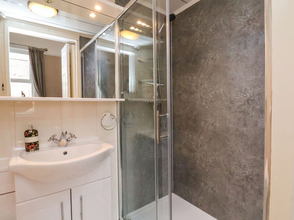 A bathroom with a shower and washbasin at Sunnyvale House in Whitby