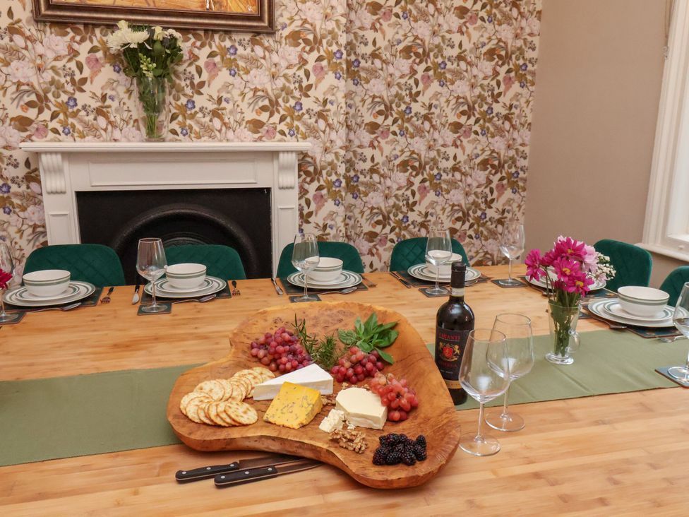 A dining room with a table set with food and drinks at Sunnyvale House in Whitby