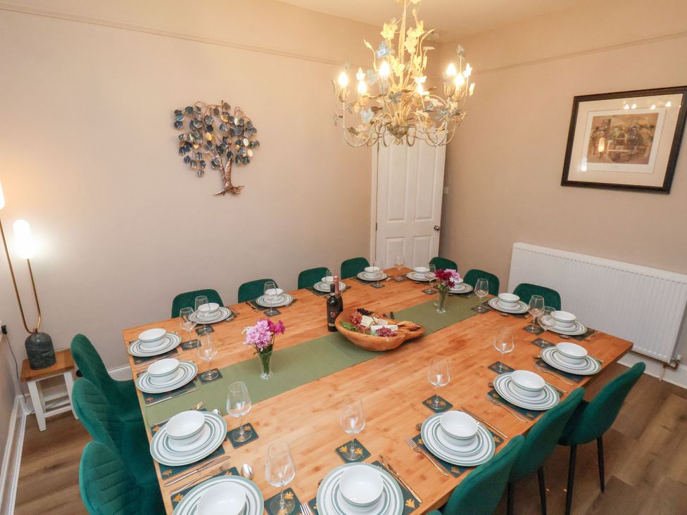 A dining room with a large table set for dinner at Sunnyvale House in Whitby