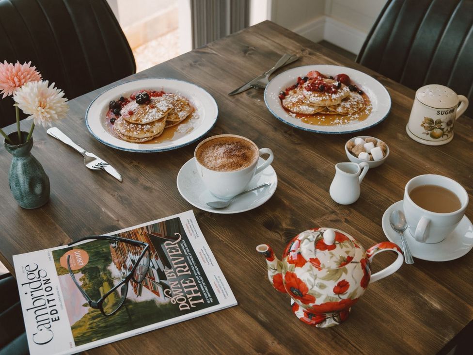 A dining table set with pancakes and drinks at The Fotheringhay in Kings Cliffe