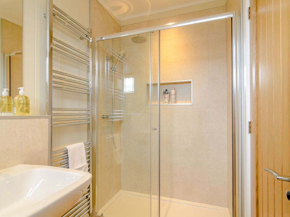 A bathroom with a shower and sink at The Fotheringhay (Pet) in Kings Cliffe