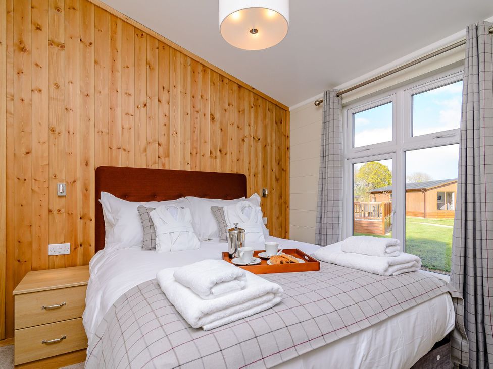 A bedroom with a bed and breakfast items on a tray at The Folkesworth (Pet) in Kings Cliffe