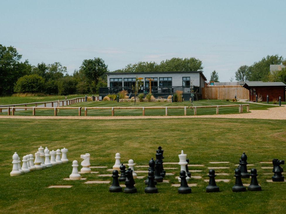 An outdoor area with large chess pieces and a building at The Folkesworth (Pet) Kings Cliffe