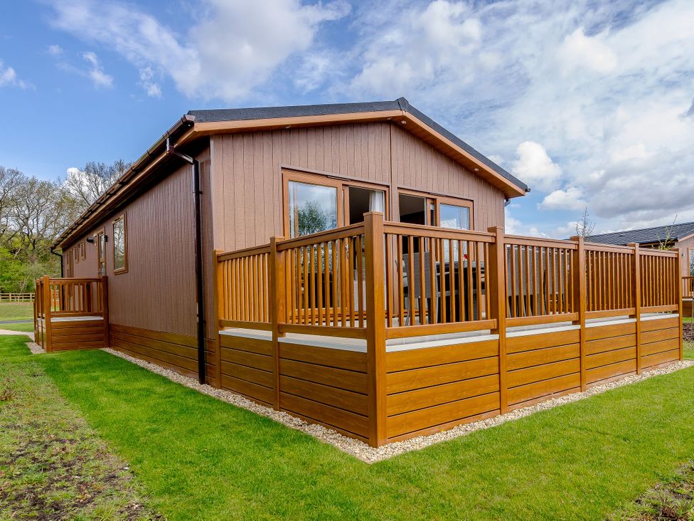 A house with decking and fence at The Alwalton (Pet) Kings Cliffe