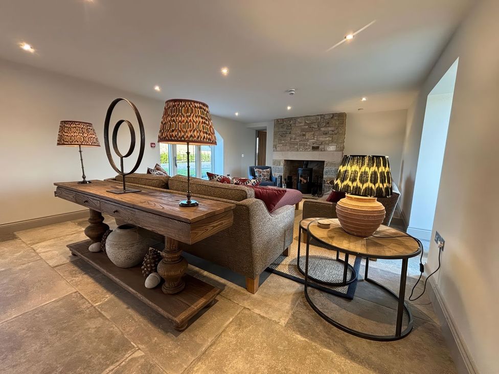 A living room with a sofa and coffee table at The Old Watermill in Beadnell