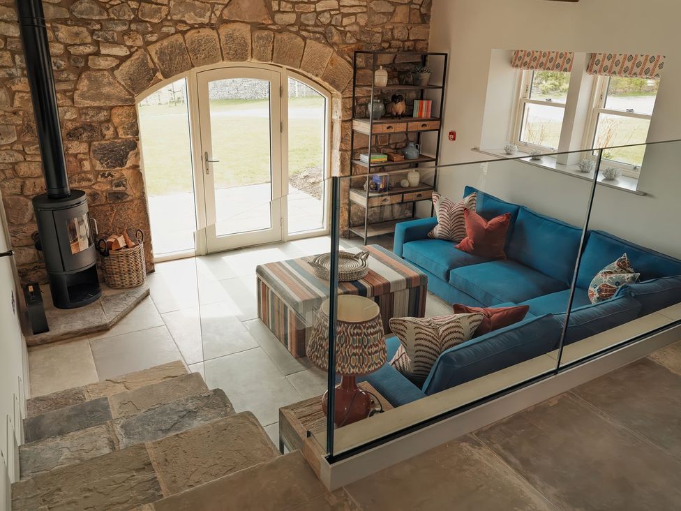 A living room with a fireplace and sofa at The Old Watermill Beadnell