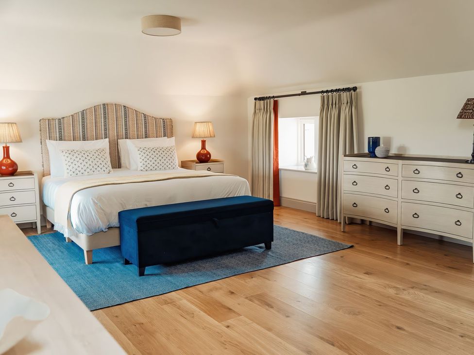 A bedroom with a bed and nightstands at The Old Watermill in Beadnell