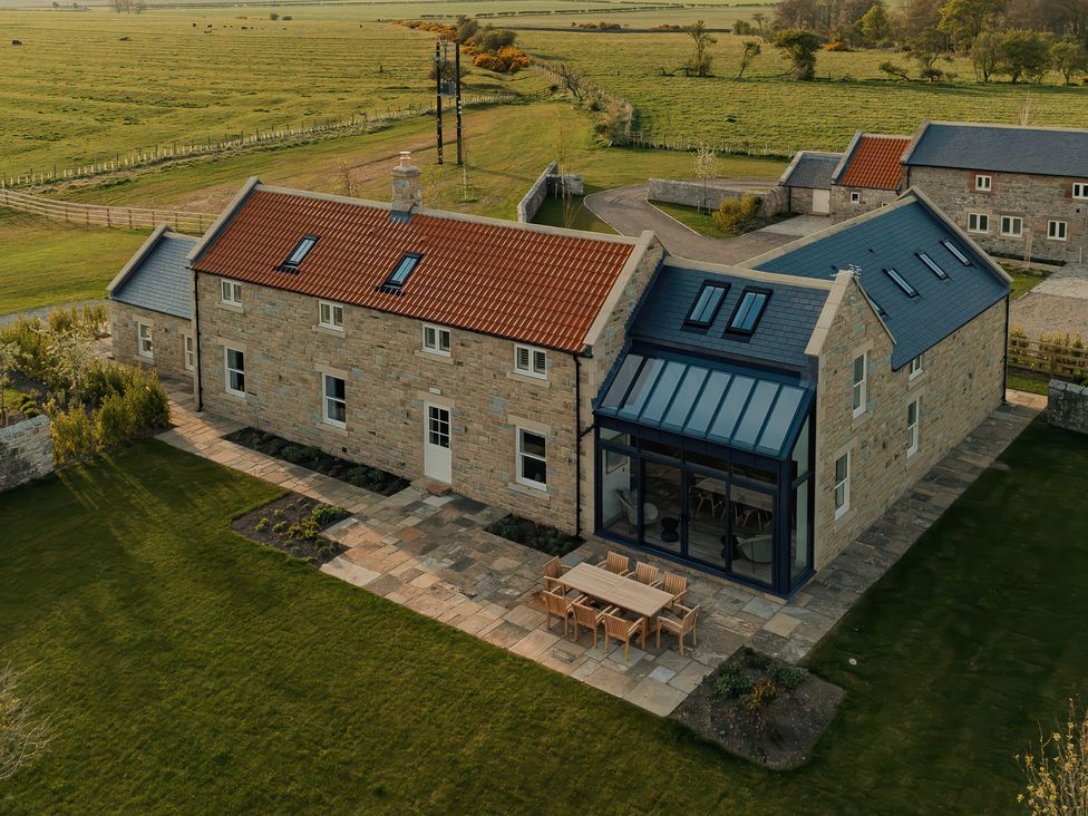 A house with outdoor seating area at Mill Farm House Beadnell