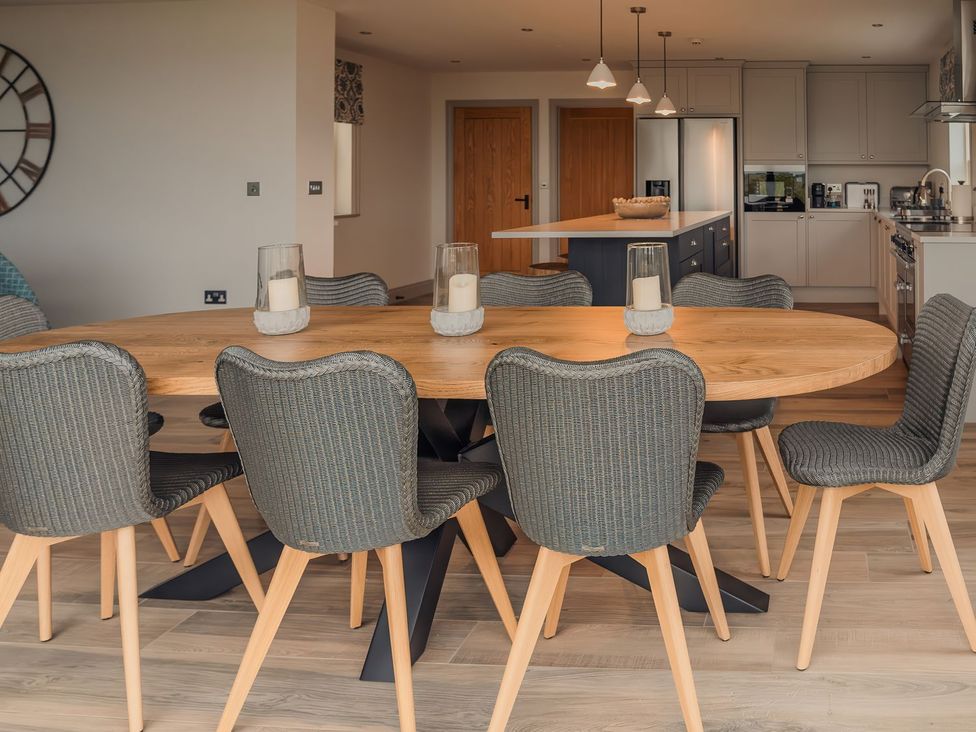A dining room with a table and chairs at Mill Farm House Beadnell