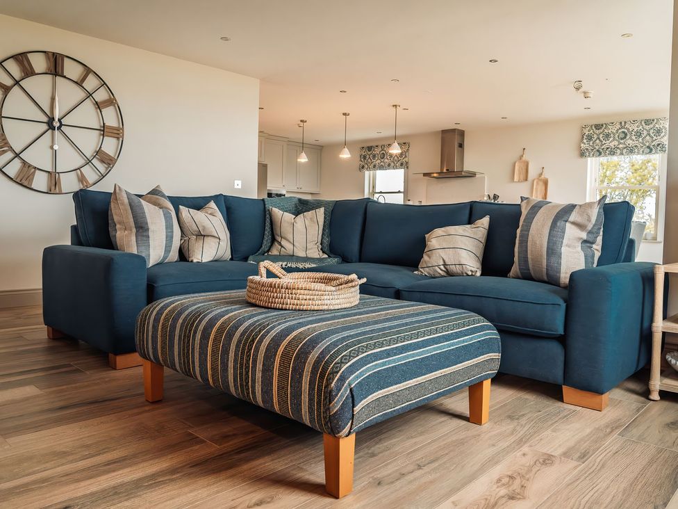 A living room with a sofa and coffee table at Mill Farm House Beadnell