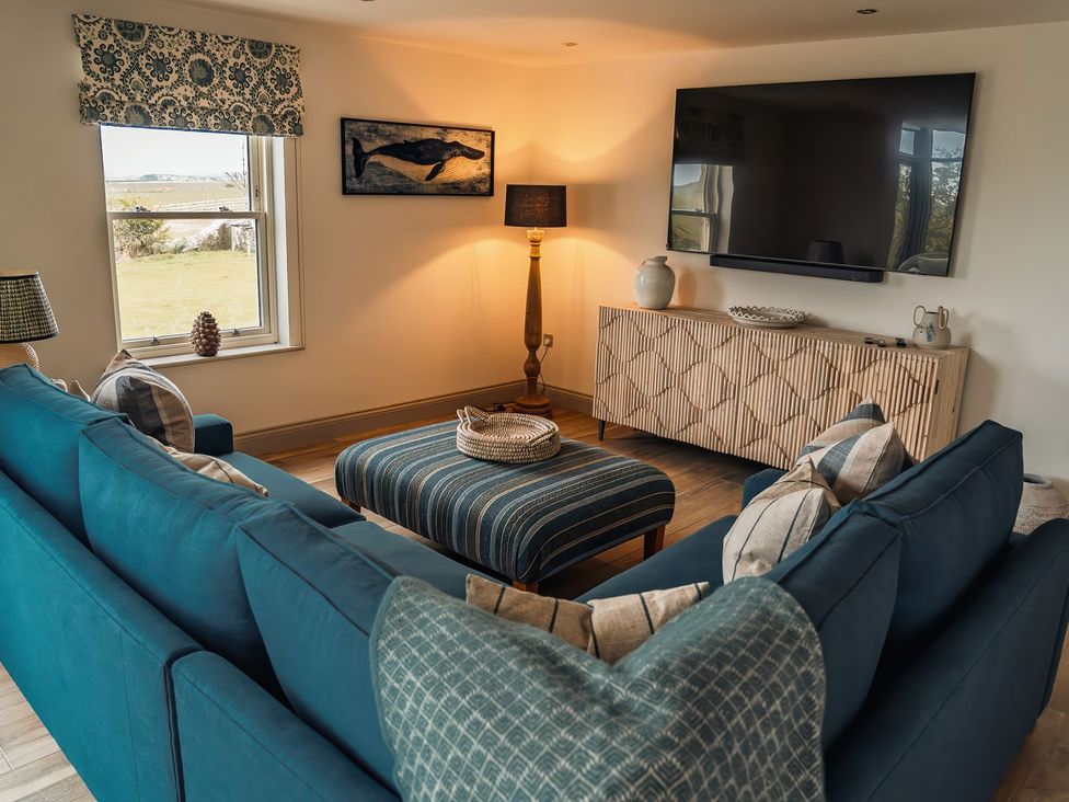 A living room with a sofa and coffee table at Mill Farm House Beadnell