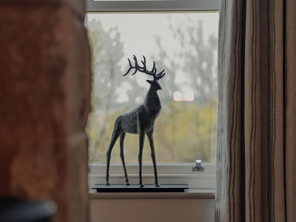A deer sculpture on a windowsill at Mill Farm House Beadnell