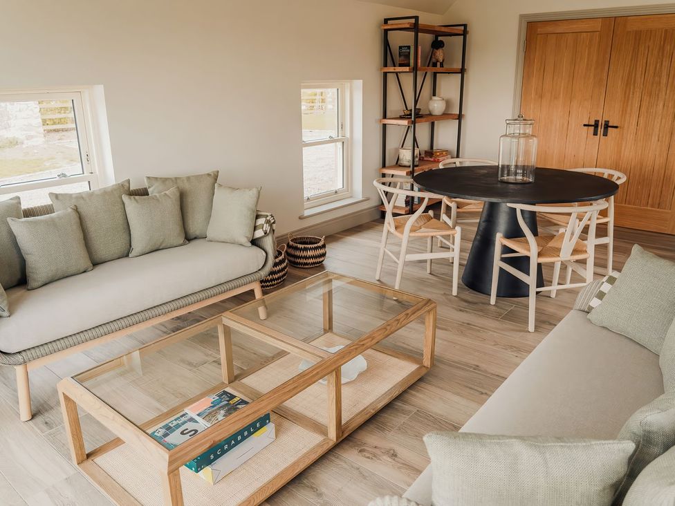 A living room with a sofa and coffee table at Mill Farm House Beadnell