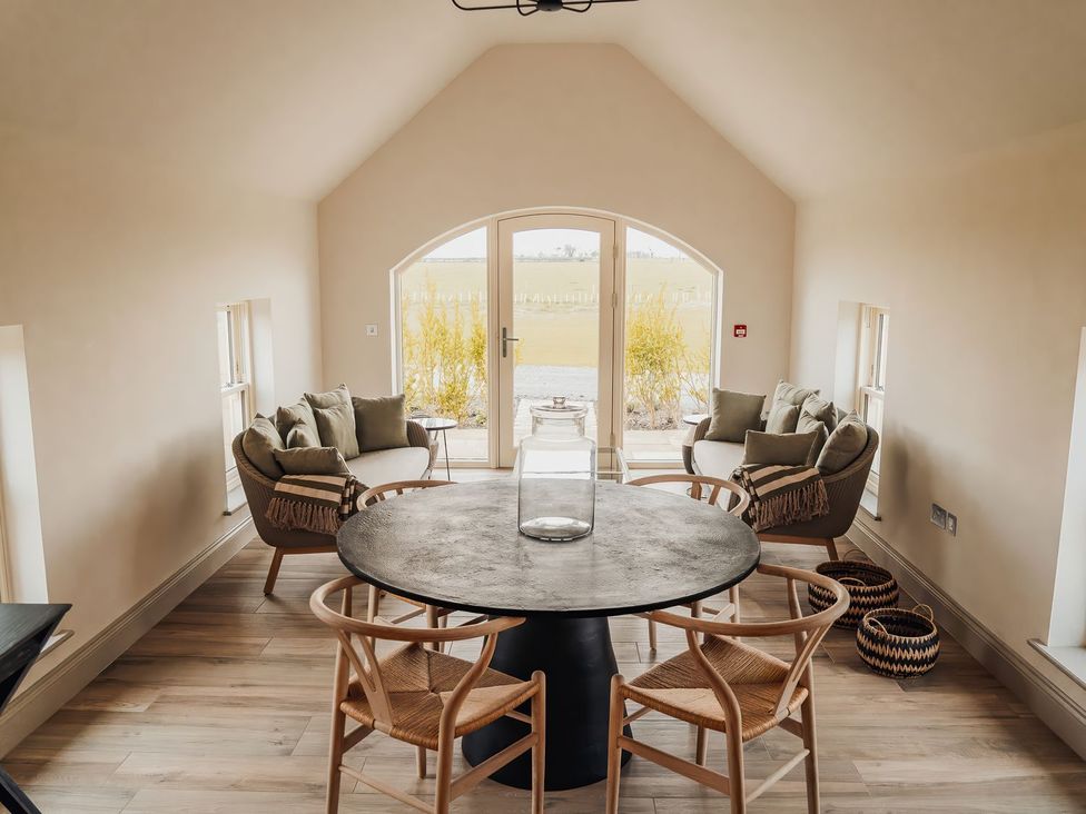 A snug with chairs and a table at Mill Farm House Beadnell