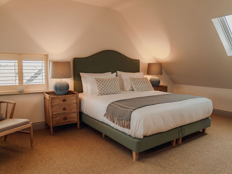 A bedroom with a bed and nightstand at Mill Farm House Beadnell