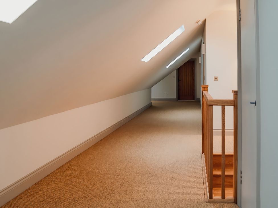 A hallway with skylights and a staircase at Mill Farm House in Beadnell