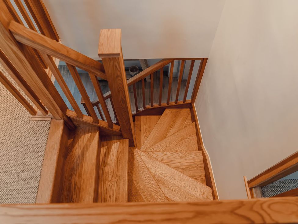 A staircase view from above at Mill Farm House in Beadnell