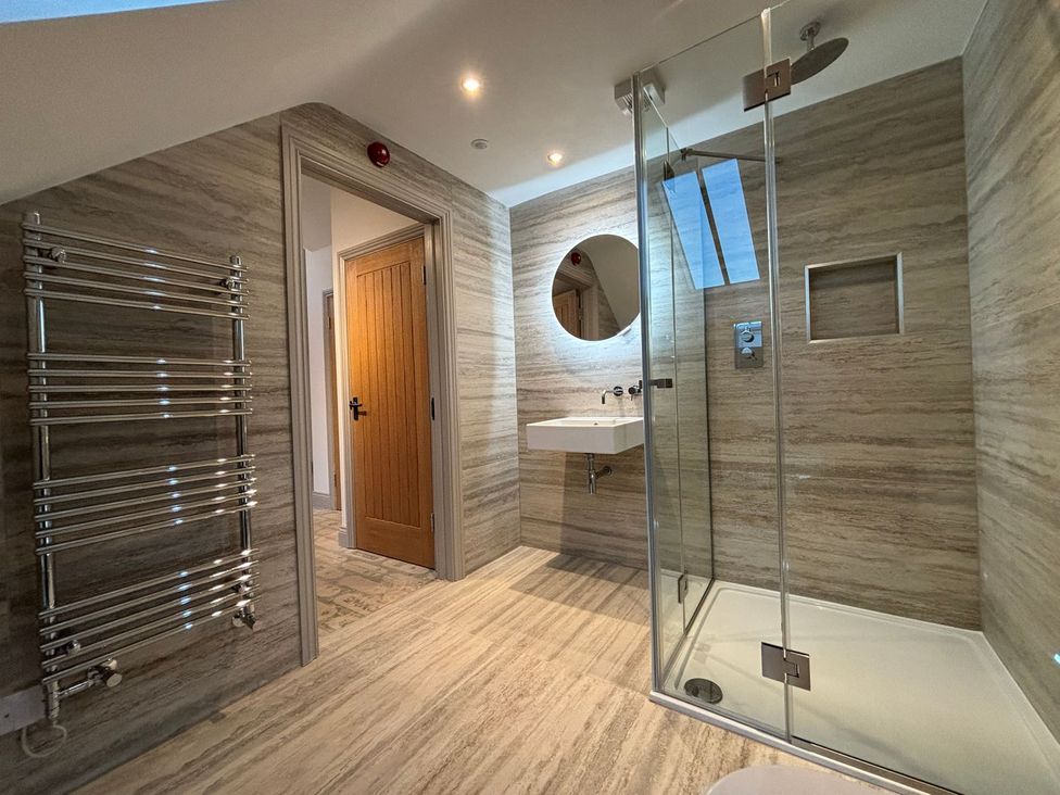 A bathroom with a shower and sink at Mill Farm House Beadnell