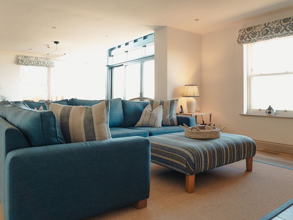A living room with a sofa and cushions at Mill Farm House Beadnell