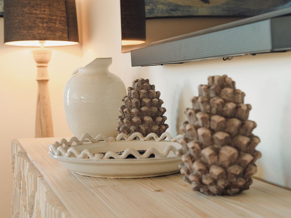 A side table with decorative items in the living room at Mill Farm House in Beadnell