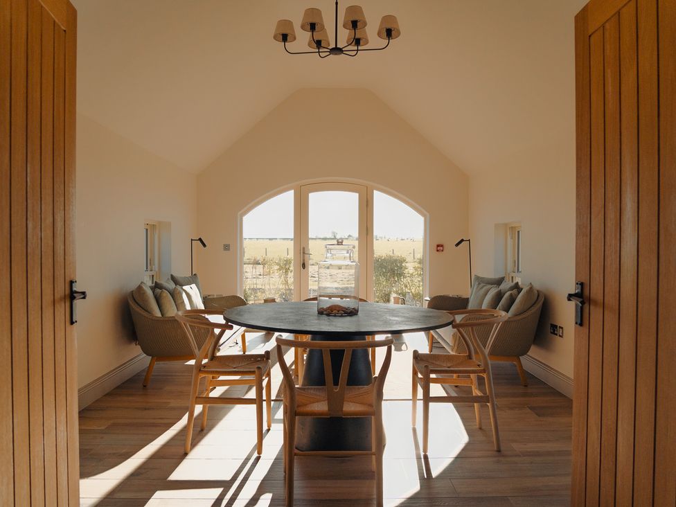 A dining room with a table and chairs at Mill Farm House Beadnell