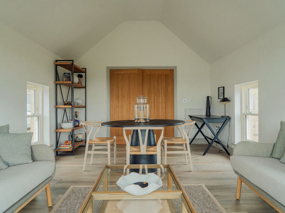 A dining room with a table and chairs at Mill Farm House Beadnell