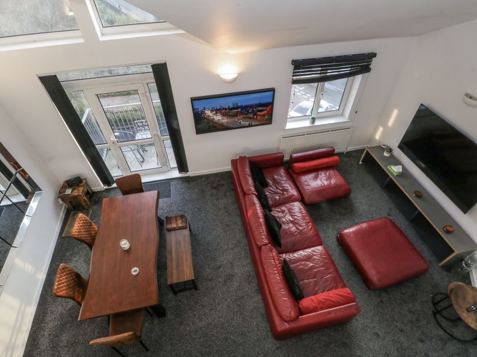 A living room with a dining table and sofa at Manchester apartment in Manchester