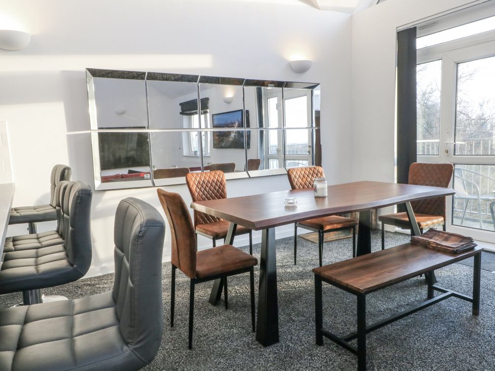 A dining room with a table and chairs at Manchester apartment in Manchester