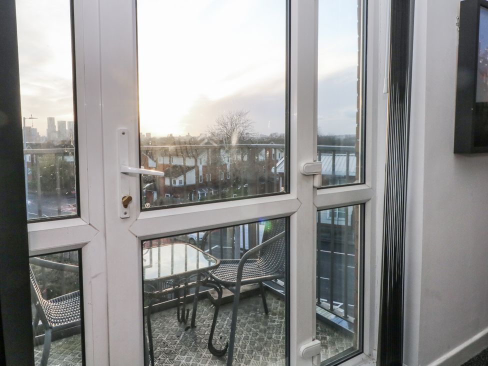 A balcony with a table and chairs at Manchester apartment in Manchester