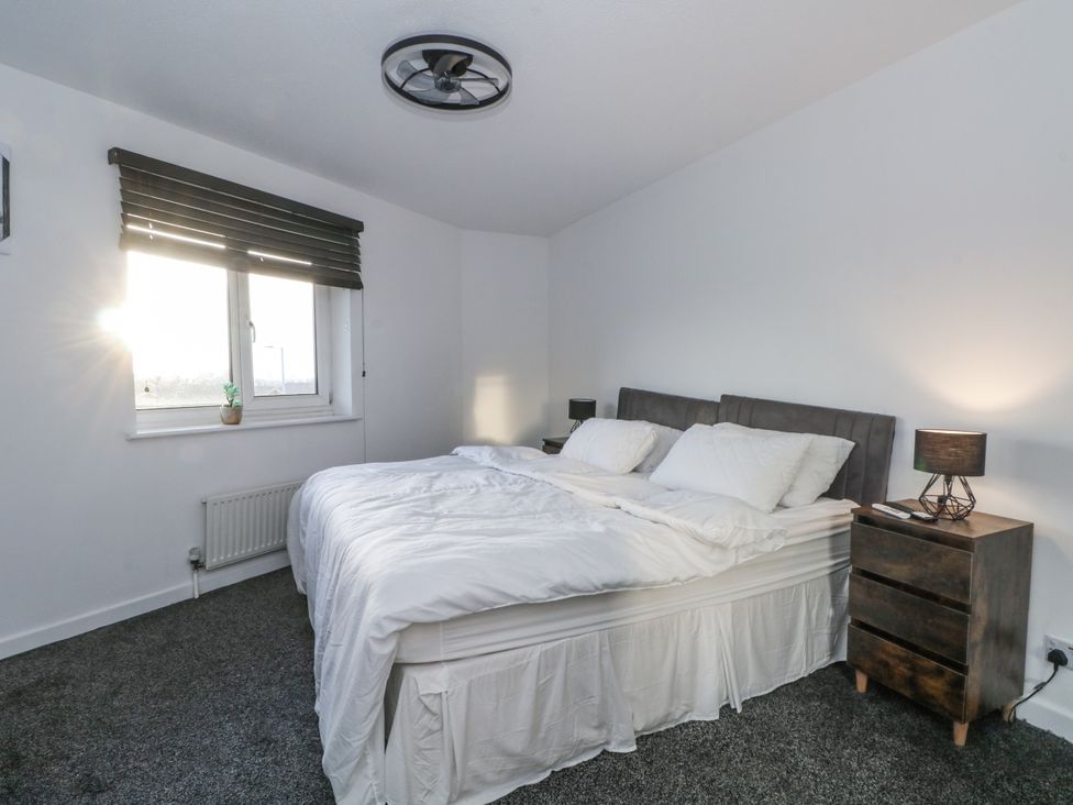 A bedroom with a bed and nightstand at Manchester apartment in Manchester