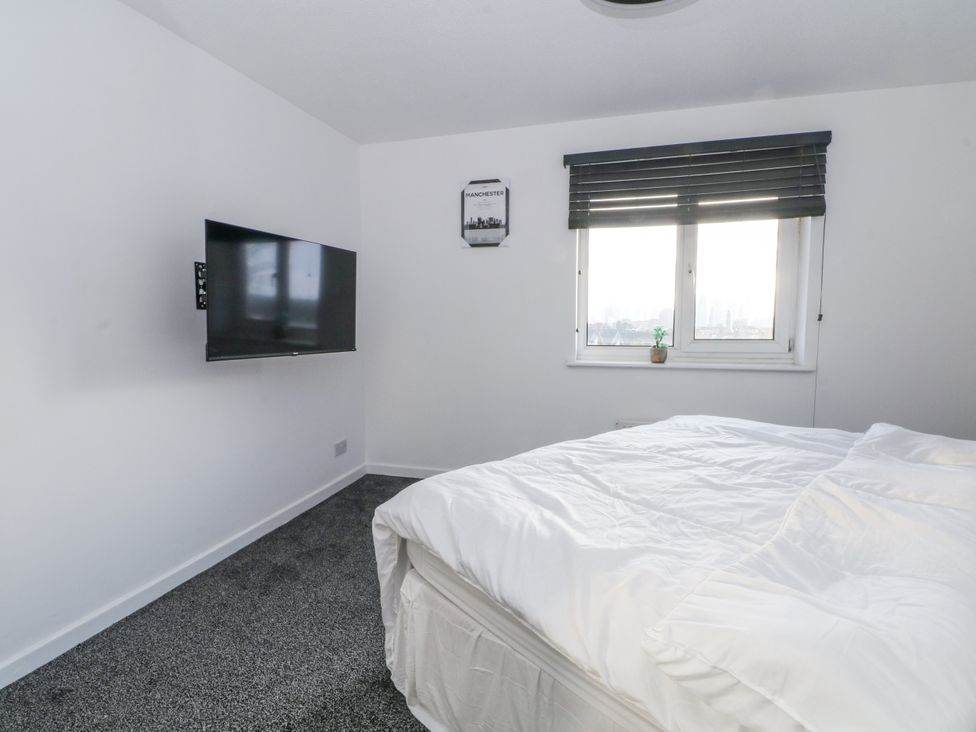 A bedroom with a bed and a television at Manchester apartment Manchester