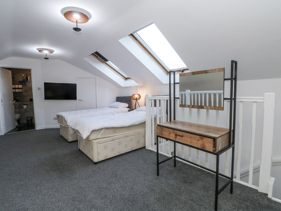 A bedroom with two beds and a dressing table at Manchester apartment in Manchester