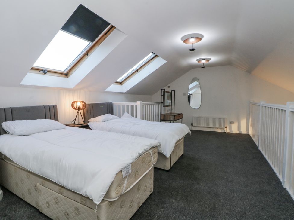A bedroom with two beds and a nightstand at Manchester apartment in Manchester