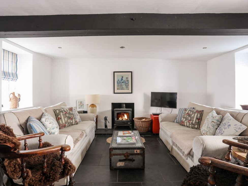 A living room with sofas and a fireplace at Bryn Tegid in Beaumaris