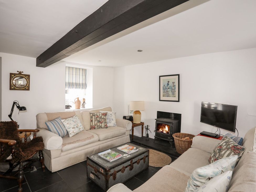 A living room with sofas and a fireplace at Bryn Tegid in Beaumaris