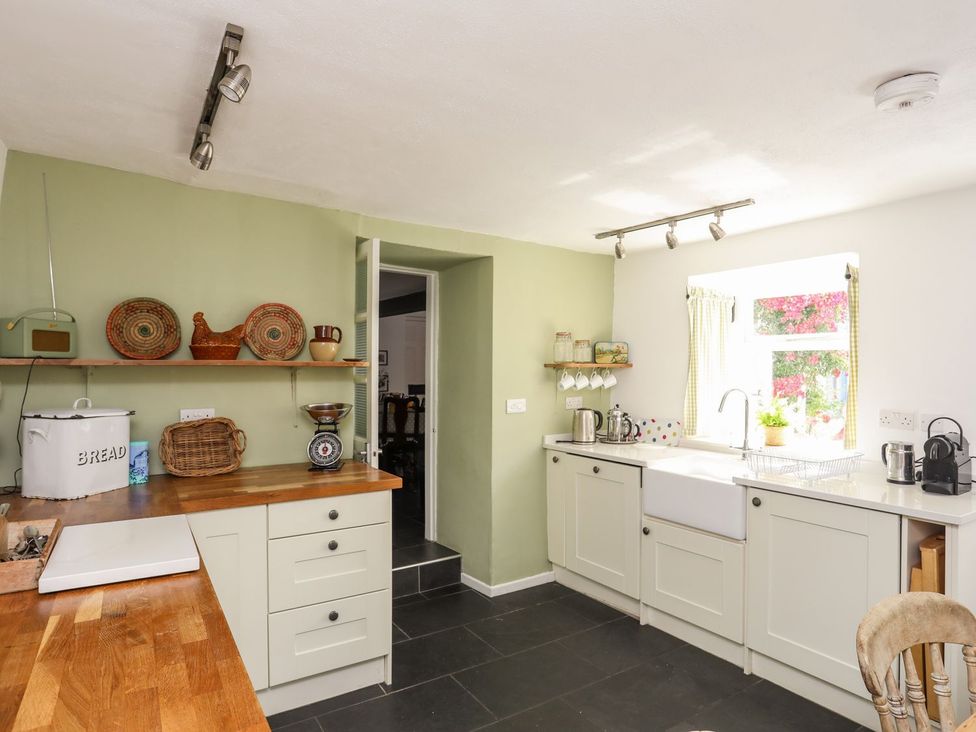 A kitchen with cabinets and a sink at Bryn Tegid in Beaumaris