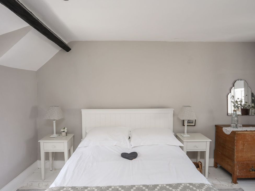 A bedroom with a bed and furniture at Bryn Tegid in Beaumaris