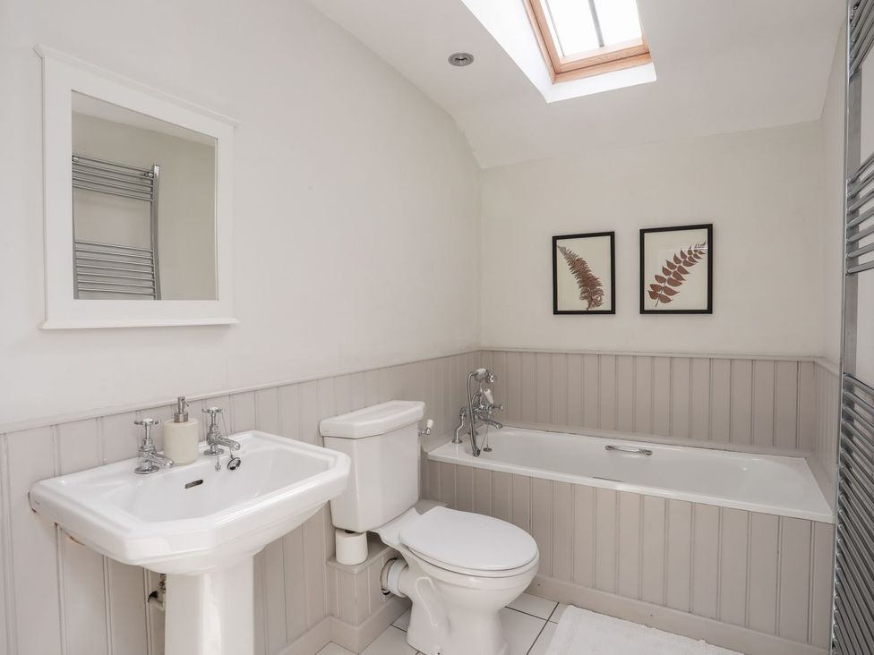 A bathroom with a bathtub and sink at Bryn Tegid in Beaumaris