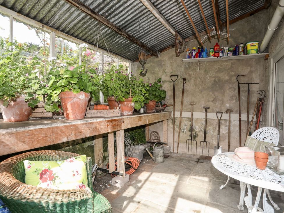A garden room with potted plants and garden tools at Bryn Tegid Beaumaris
