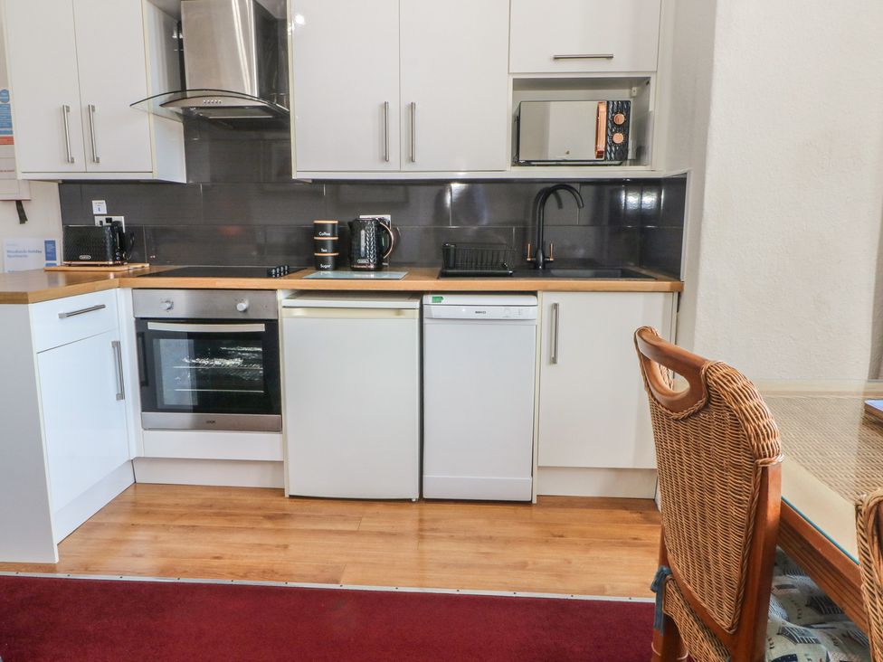 A kitchen with cabinets and appliances at Apartment 1