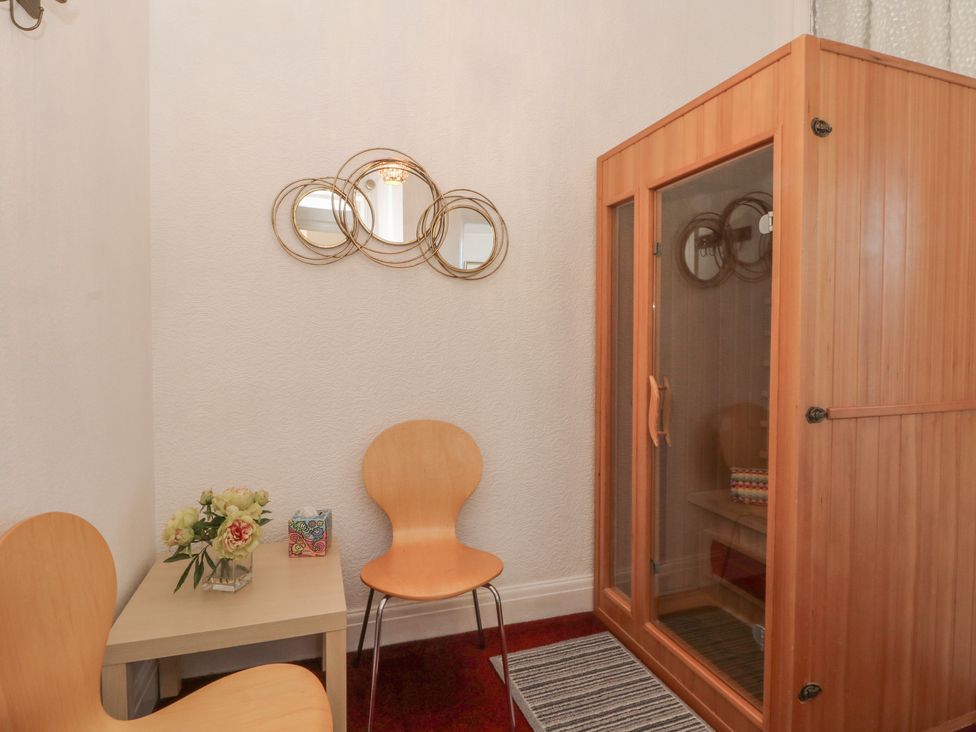 A spa room with a sauna and two chairs at Apartment 1