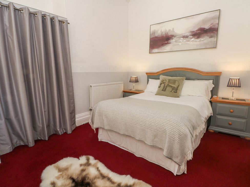 A bedroom with a bed and bedside table at Apartment 1