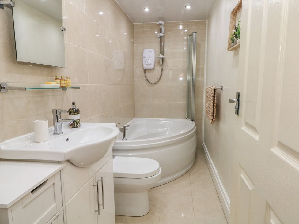 A bathroom with a bath tub, sink and toilet at Apartment 1