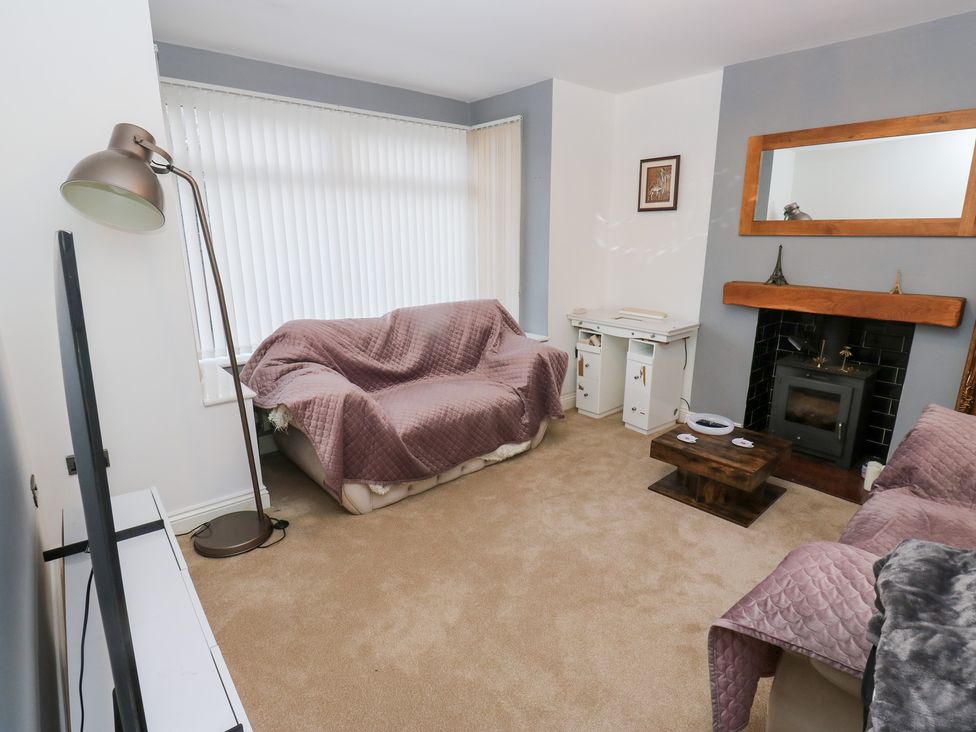 A living room with a sofa and a fireplace at Middleton Park House in Leeds