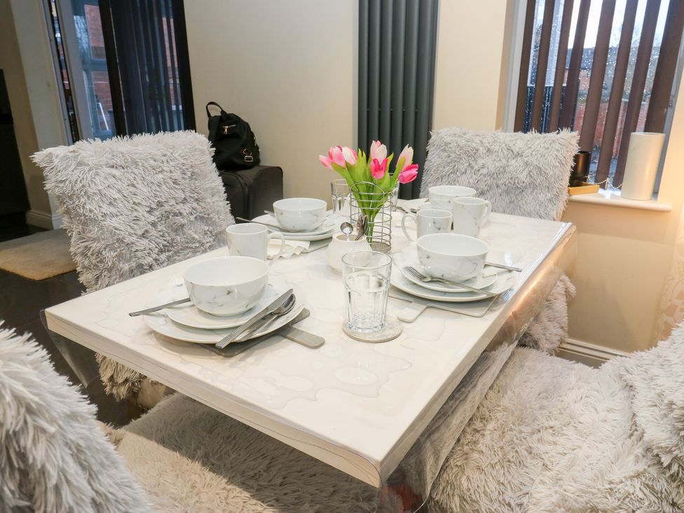 A dining table set with dishes and flowers at Middleton Park House in Leeds