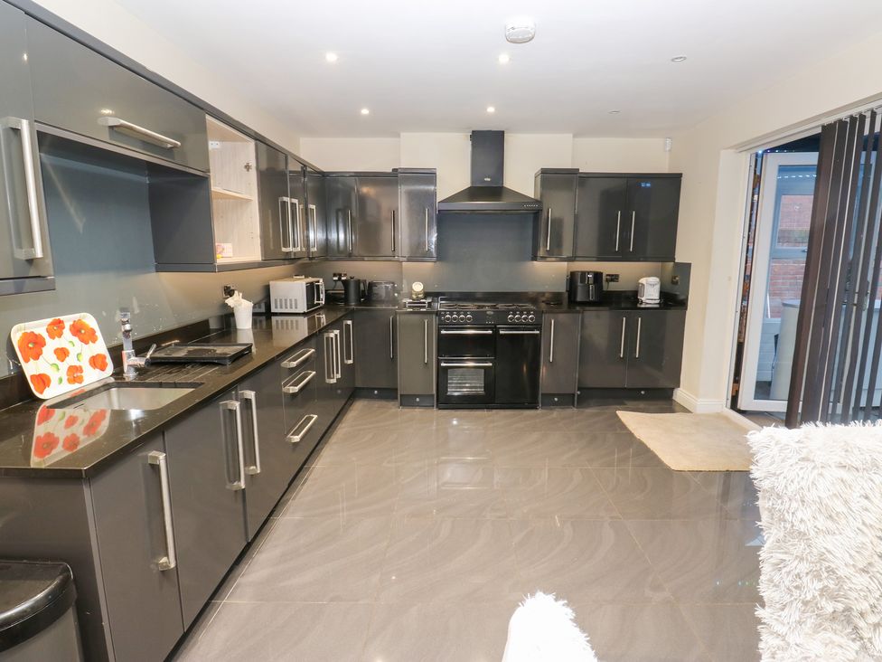 A kitchen with cabinets and appliances at Middleton Park House in Leeds